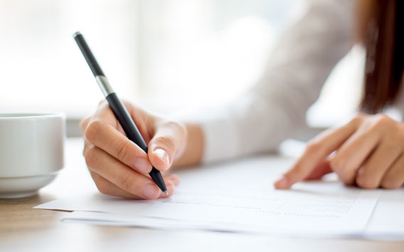 Woman writing on a piece of paper